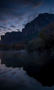 Preview wallpaper mountains, lake, reflection, trees, stones, fog, clouds