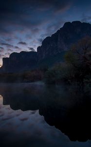 Preview wallpaper mountains, lake, reflection, trees, stones, fog, clouds