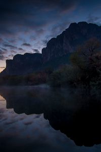 Preview wallpaper mountains, lake, reflection, trees, stones, fog, clouds