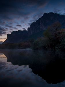 Preview wallpaper mountains, lake, reflection, trees, stones, fog, clouds