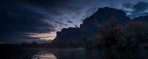 Preview wallpaper mountains, lake, reflection, trees, stones, fog, clouds