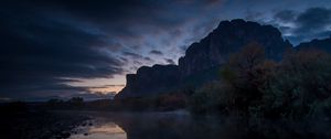 Preview wallpaper mountains, lake, reflection, trees, stones, fog, clouds