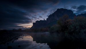 Preview wallpaper mountains, lake, reflection, trees, stones, fog, clouds