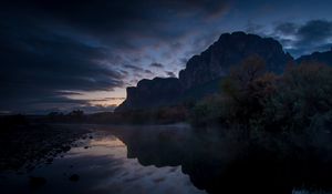 Preview wallpaper mountains, lake, reflection, trees, stones, fog, clouds
