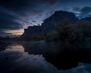 Preview wallpaper mountains, lake, reflection, trees, stones, fog, clouds