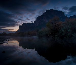 Preview wallpaper mountains, lake, reflection, trees, stones, fog, clouds