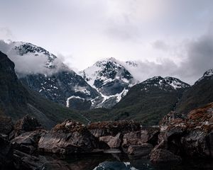 Preview wallpaper mountains, lake, reflection, rocks, clouds, snowy