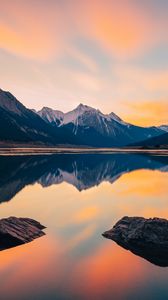 Preview wallpaper mountains, lake, stones, snowy, sunset