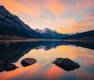 Preview wallpaper mountains, lake, stones, snowy, sunset