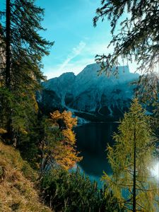 Preview wallpaper mountains, lake, trees, branches, sky, clouds
