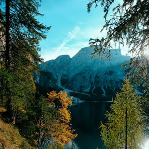 Preview wallpaper mountains, lake, trees, branches, sky, clouds