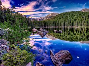 Preview wallpaper mountains, lake, wood, coast, reflection, mirror, clouds, brightly, sky, snag, stones, contrast