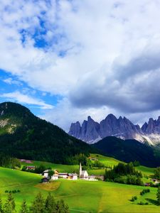 Preview wallpaper mountains, mountain range, village, clouds, grass, trees