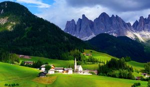 Preview wallpaper mountains, mountain range, village, clouds, grass, trees