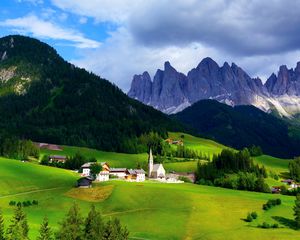 Preview wallpaper mountains, mountain range, village, clouds, grass, trees