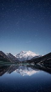 Preview wallpaper mountains, night, starry sky, reflection, snowy