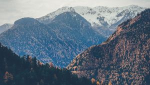 Preview wallpaper mountains, peaks, autumn, snowy, trees, sky