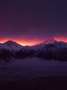 Preview wallpaper mountains, peaks, fog, sunset, sky, snow, clouds, dark