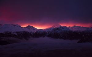 Preview wallpaper mountains, peaks, fog, sunset, sky, snow, clouds, dark