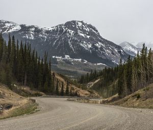 Preview wallpaper mountains, peaks, road, forest, snowy