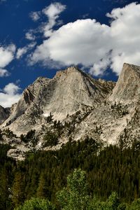 Preview wallpaper mountains, peaks, rocks, trees, spruce, sky