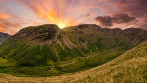 Preview wallpaper mountains, peaks, sunset, grass, meadow