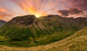 Preview wallpaper mountains, peaks, sunset, grass, meadow