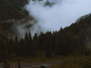 Preview wallpaper mountains, pines, trees, fog, road, car, nature