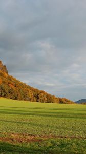 Preview wallpaper mountains, plain, clouds, grass, green, trees, shadow