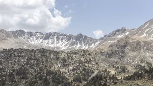 Preview wallpaper mountains, pond, trees, grass, stones, sky, clouds