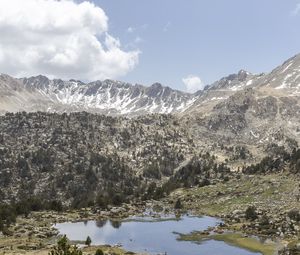 Preview wallpaper mountains, pond, trees, grass, stones, sky, clouds