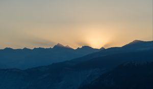 Preview wallpaper mountains, relief, sun, rays, twilight, dark