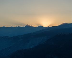 Preview wallpaper mountains, relief, sun, rays, twilight, dark