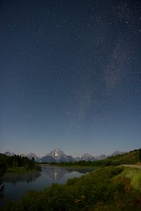Preview wallpaper mountains, river, bushes, starry sky, stars, night