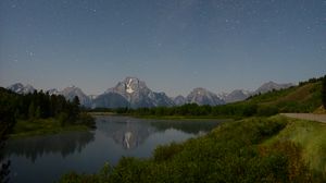 Preview wallpaper mountains, river, bushes, starry sky, stars, night