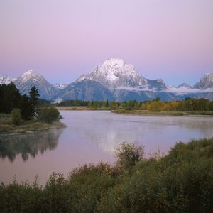 Preview wallpaper mountains, river, coast, vegetation, evening, trees, tops, clouds