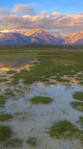 Preview wallpaper mountains, river, vegetation, evening, bottom, cracks