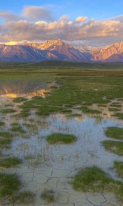 Preview wallpaper mountains, river, vegetation, evening, bottom, cracks