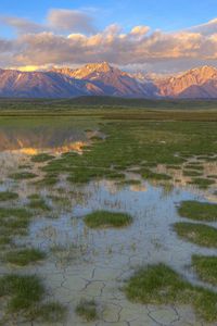 Preview wallpaper mountains, river, vegetation, evening, bottom, cracks