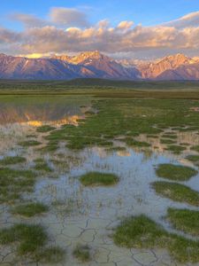 Preview wallpaper mountains, river, vegetation, evening, bottom, cracks