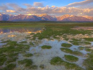 Preview wallpaper mountains, river, vegetation, evening, bottom, cracks