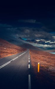Preview wallpaper mountains, road, asphalt, marking, lake, dark, clouds