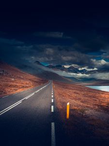 Preview wallpaper mountains, road, asphalt, marking, lake, dark, clouds