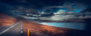 Preview wallpaper mountains, road, asphalt, marking, lake, dark, clouds