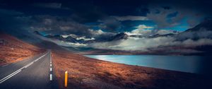 Preview wallpaper mountains, road, asphalt, marking, lake, dark, clouds