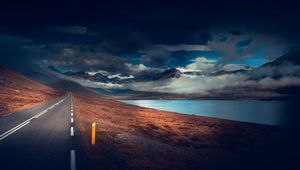 Preview wallpaper mountains, road, asphalt, marking, lake, dark, clouds