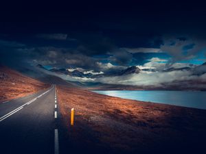 Preview wallpaper mountains, road, asphalt, marking, lake, dark, clouds