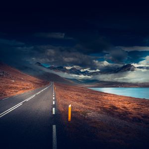 Preview wallpaper mountains, road, asphalt, marking, lake, dark, clouds