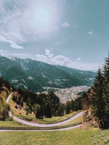 Preview wallpaper mountains, road, landscape, sun, trees, slope