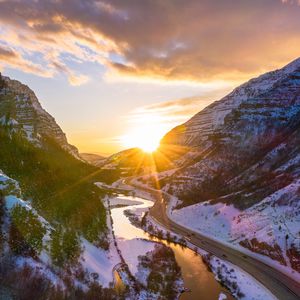 Preview wallpaper mountains, road, river, sun, landscape